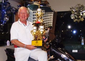 Jan Johansson poses with the series trophy and his gleaming new Honda Click motorcycle.
